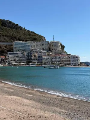 a beach in front of a city with buildings at Apartman Dejan Rafailovici in Rafailovici