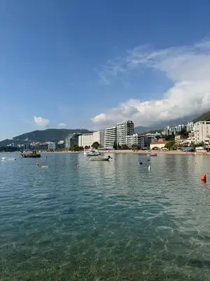 a large body of water with a city in the background at Apartman Dejan Rafailovici in Rafailovici