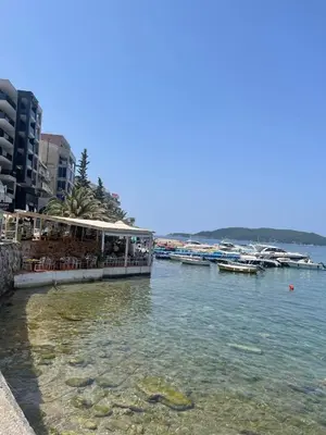 a view of a body of water with boats at Apartman Dejan Rafailovici in Rafailovici