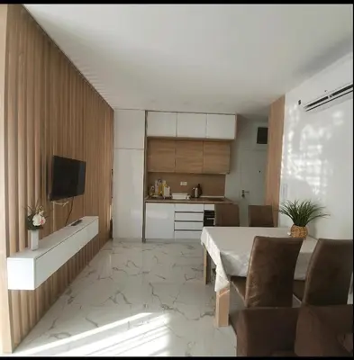 a kitchen and dining room with a table and chairs at Sirius apartaments in Rafailovici