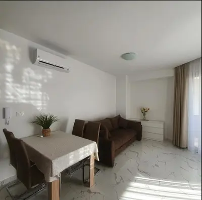 a living room with a couch and a table at Sirius apartaments in Rafailovici