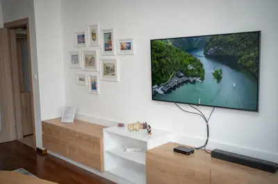 a living room with a flat screen tv on a wall at Apartment Minna Master Quart in Podgorica