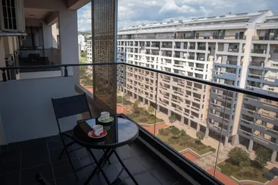 a balcony with a table and a view of a building at Apartment Minna Master Quart in Podgorica