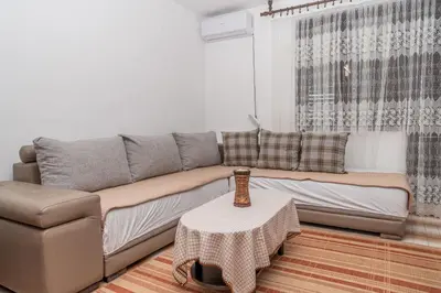 a living room with a couch and a table at Apartman Glendza in Ulcinj