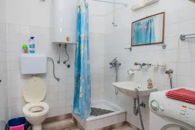 a bathroom with a toilet and a sink at Apartman Glendza in Ulcinj