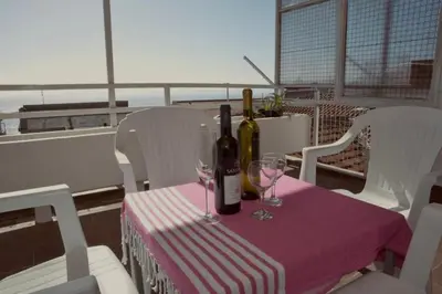 a table with two bottles of wine and two glasses at Apartman Glendza in Ulcinj