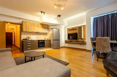 a living room with a couch and a kitchen at Apartments RONDO in Ulcinj
