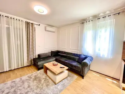 a living room with a couch and a coffee table at BS Apartman in Podgorica