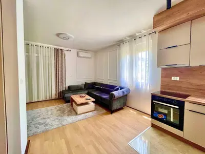 a living room with a couch and a table at BS Apartman in Podgorica