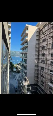 a tall building with a view of a street at Apartman Ema in Budva