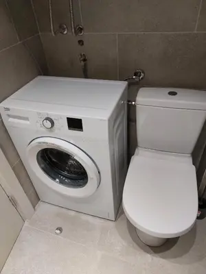 a washing machine and a toilet in a bathroom at Apartman Ema in Budva