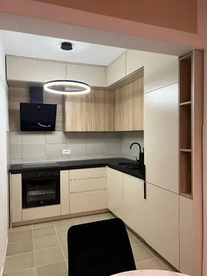 a kitchen with white cabinets and a black counter top at Two bedroom lux apartment in Budva