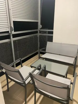 two chairs and a table on a balcony at Two bedroom lux apartment in Budva