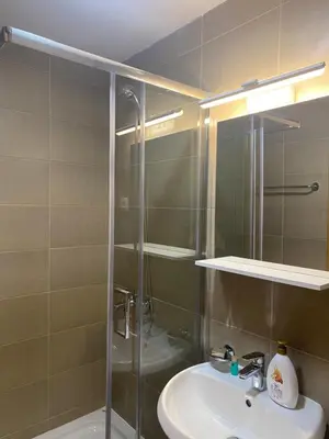 a bathroom with a sink and a shower at Two bedroom lux apartment in Budva