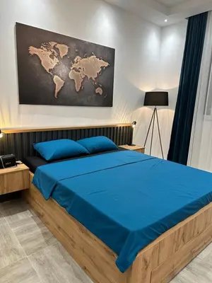 a bedroom with a bed with a map on the wall at Apartmani Kralj in Bar