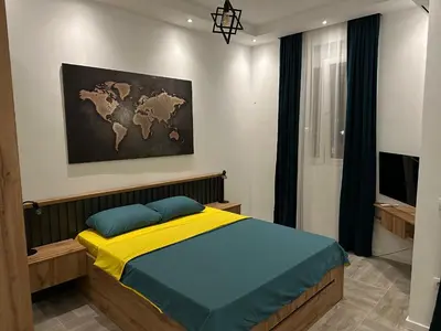 a bedroom with a bed with a map on the wall at Apartmani Kralj in Bar