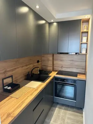 a kitchen with a sink and a stove and cabinets at Apartmani Kralj in Bar