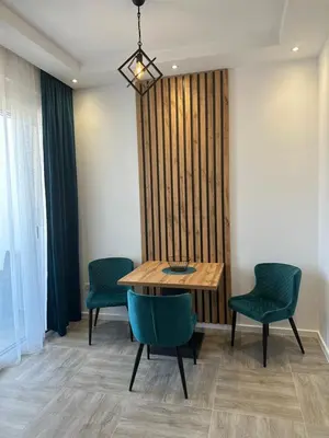 a dining room with a table and two chairs at Apartmani Kralj in Bar