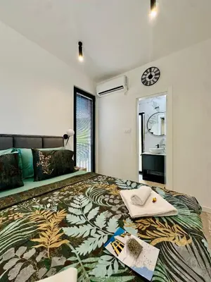 a bedroom with a large bed with a table and a mirror at Adriatic Dream in Tivat