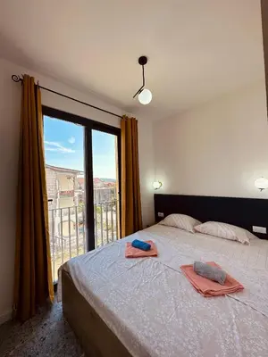 a bedroom with a bed and a large window at Adriatic Dream in Tivat