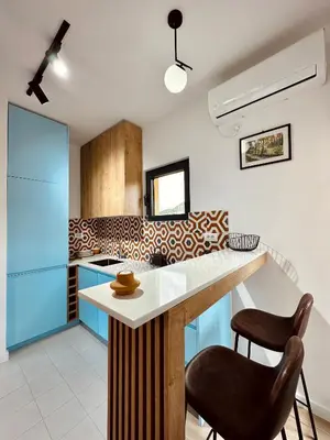 a kitchen with a counter and two stools at Adriatic Dream in Tivat