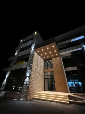 a building with lights on it at night at Apartman Sun in Ulcinj