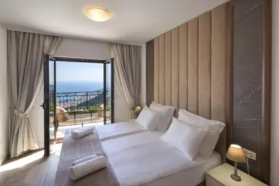 a bedroom with a large bed and a balcony at Luxury Villa Flower in Budva