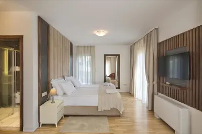 a bedroom with a bed and a flat screen tv at Luxury Villa Flower in Budva