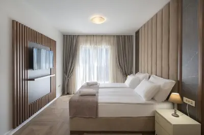 a bedroom with a large bed and a window at Luxury Villa Flower in Budva
