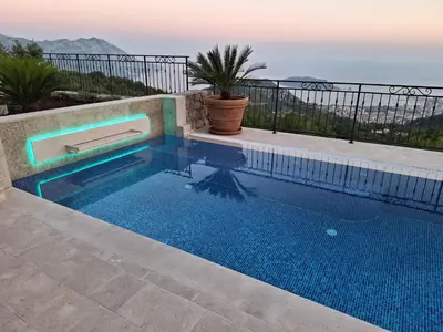 a swimming pool with a view of the ocean at Luxury Villa Flower in Budva