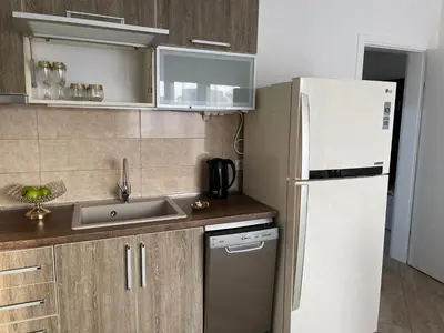 a kitchen with a white refrigerator and a sink at Villa Sunshine in Bar