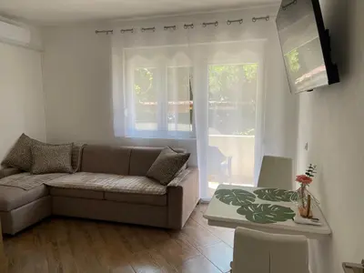 a living room with a couch and a table at Villa Sunshine in Bar