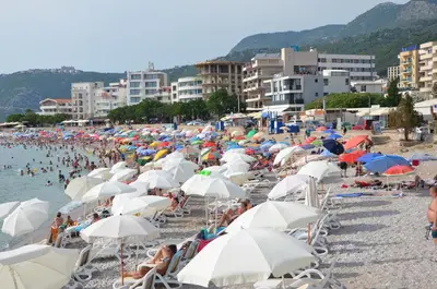 a bunch of people on a beach with umbrellas at Villa Sunshine in Bar