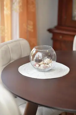 a glass bowl with seashells on a table at Apartment Nikolija in Dobrota