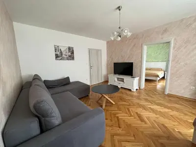 a living room with a couch and a television at Heart of the City in Budva
