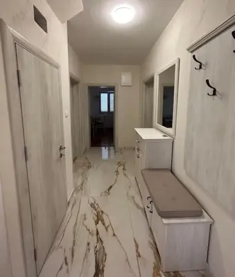 a white bathroom with a marble floor with a sink at Heart of the City in Budva