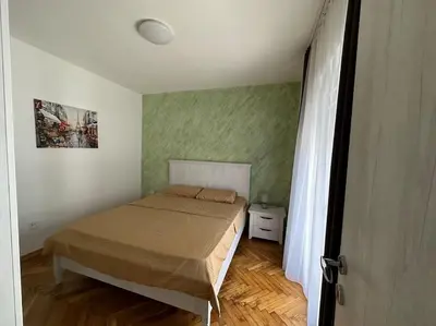 a small bedroom with a bed and a window at Heart of the City in Budva
