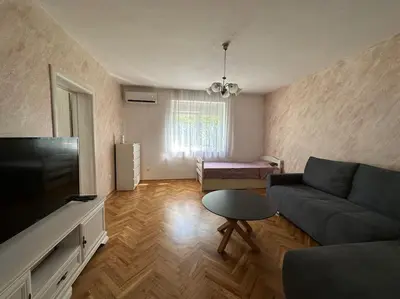 a living room with a couch and a flat screen tv at Heart of the City in Budva