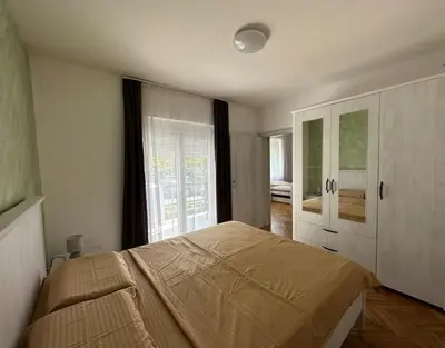 a bedroom with a bed and a large window at Heart of the City in Budva