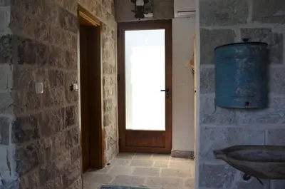 a room with a door and a window and a sink at Markovic Winery and Estate apartments in Cetinje