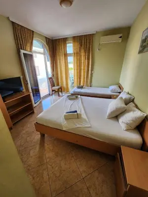 a hotel room with a bed and a television at Apartment FLORA in Bregvija