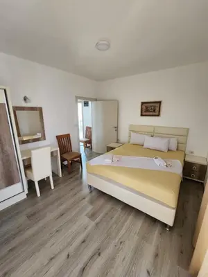 a bedroom with a bed and a table and chairs at Apartment FLORA in Bregvija