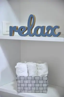 a basket of towels on a shelf with the word race at LUX Apartment TEAM JOKIC in Becici