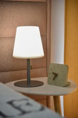 a lamp and a clock sitting on a table at LUX Apartment TEAM JOKIC in Becici