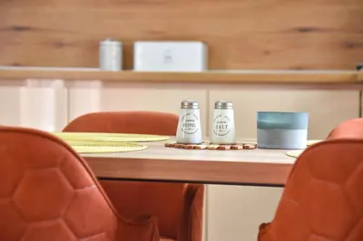 a table with two salt and pepper shakers on it at LUX Apartment TEAM JOKIC in Becici