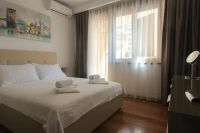 a bedroom with a bed with towels on it at Anatolija Apartment 11 in Budva