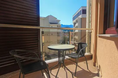 a balcony with two chairs and a table on a balcony at Anatolija Apartment 11 in Budva