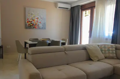 a living room with a couch and a table at Anatolija Apartment 11 in Budva