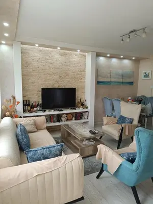 a living room with couches and a flat screen tv at Nikolaj in Podgorica