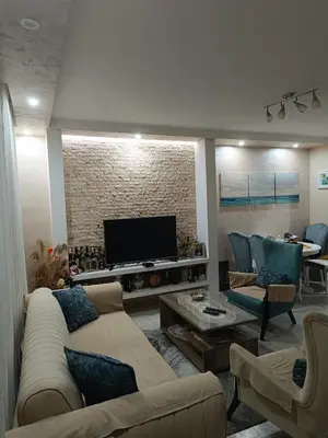 a living room with couches and a flat screen tv at Nikolaj in Podgorica